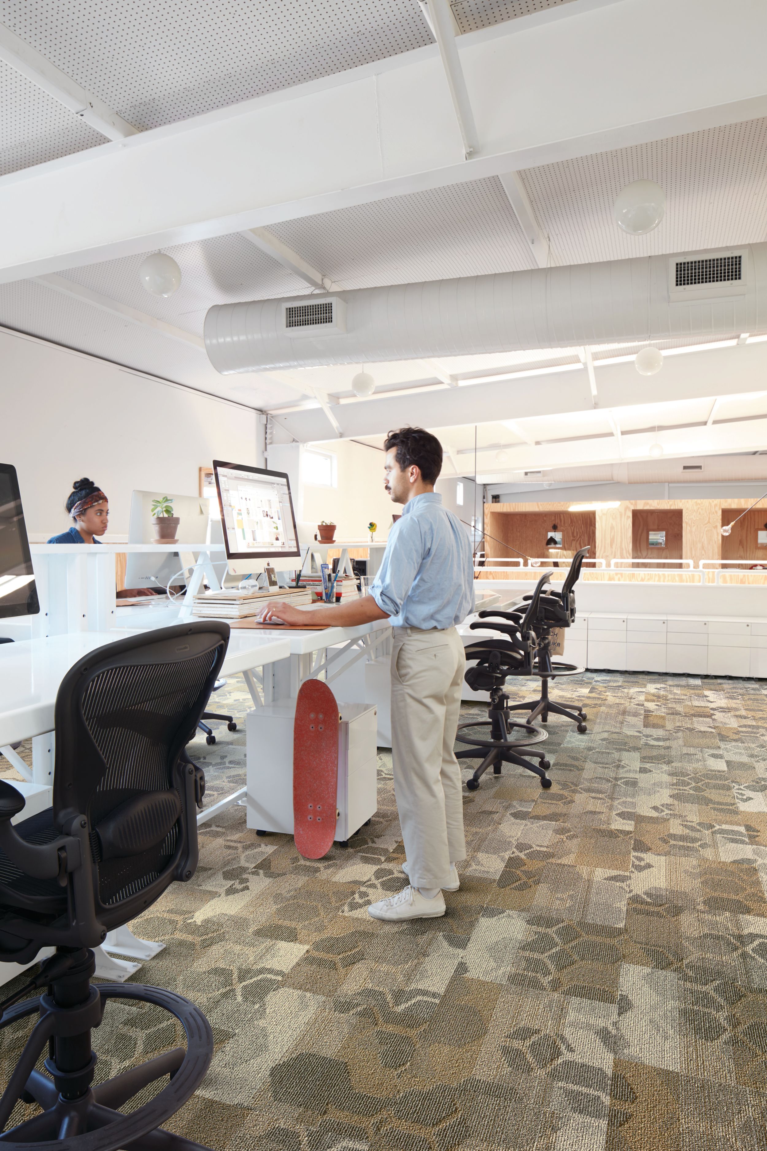 Interface Honey Don't carpet tiles with multiple standup workspaces with man working on computer image number 1